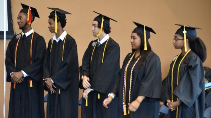 Image of trio students in graduation attire